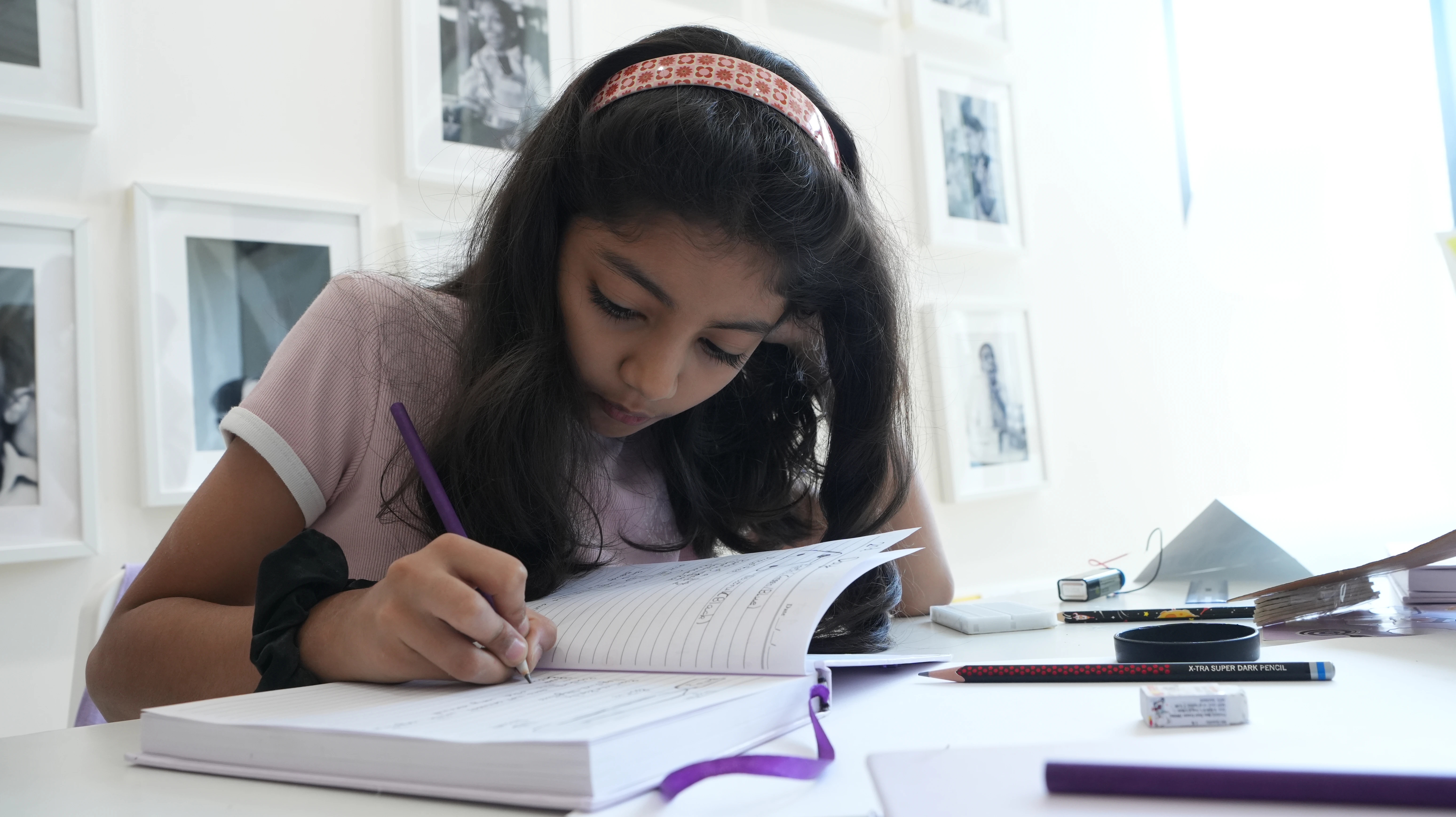 A student using a small kitchen timer next to a notebook, focusing during a short study session at a quiet desk